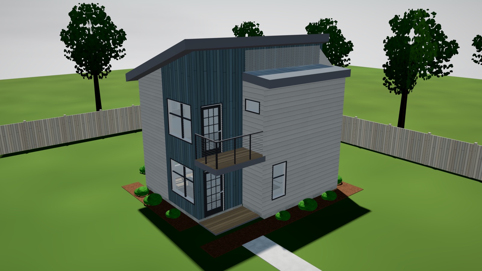 Two-story modern ADU with a shed roof, dark vertical siding, an entry deck and a balcony