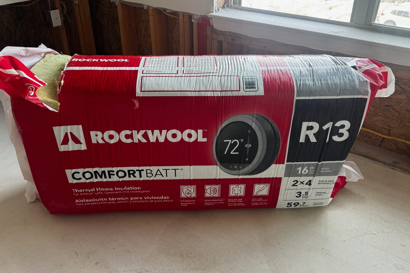 Package of R-13 mineral wool insulation batts for 2x4 walls on a renovation floor