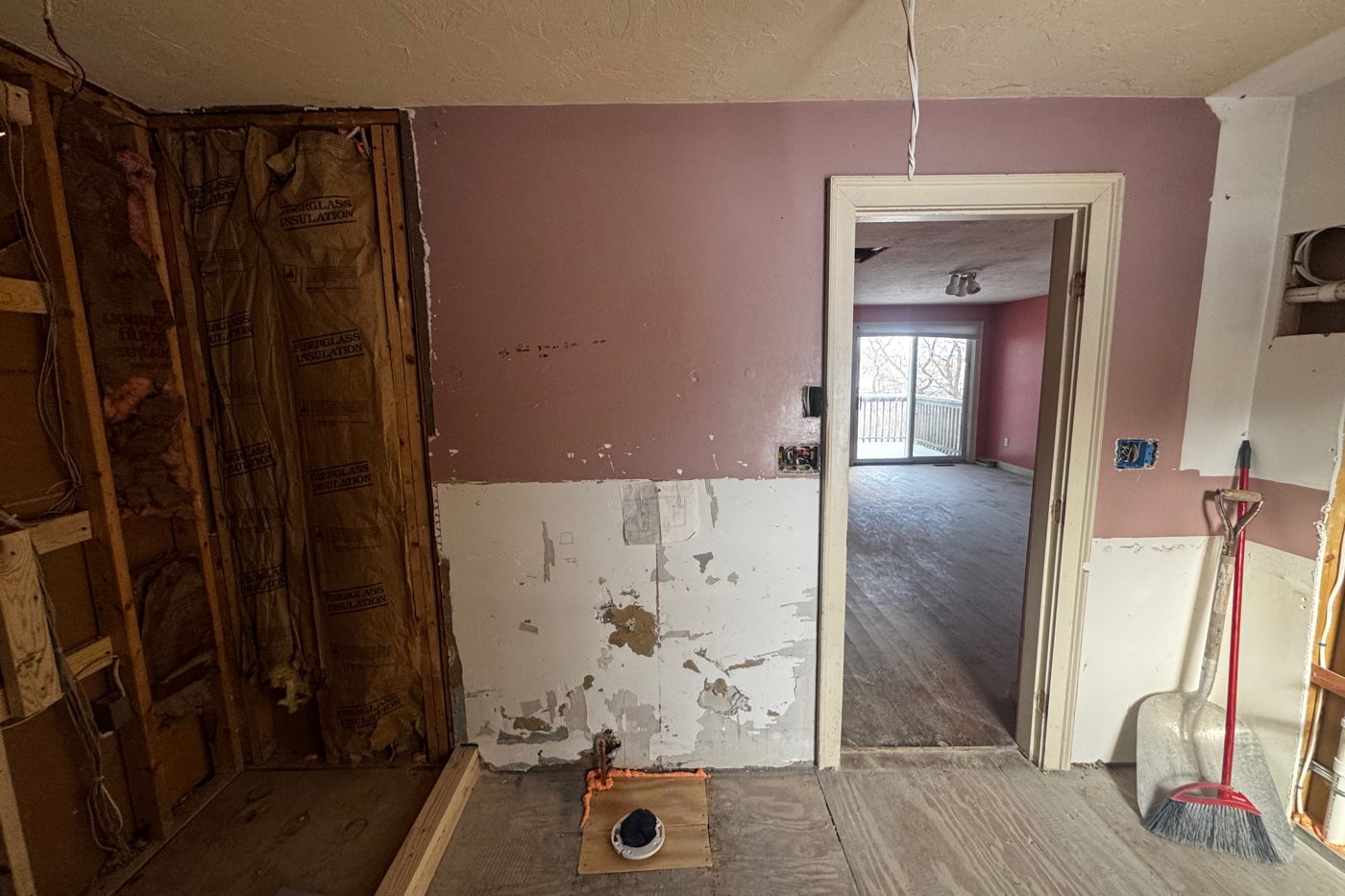 Old house room with exterior walls opened to the framing during a renovation