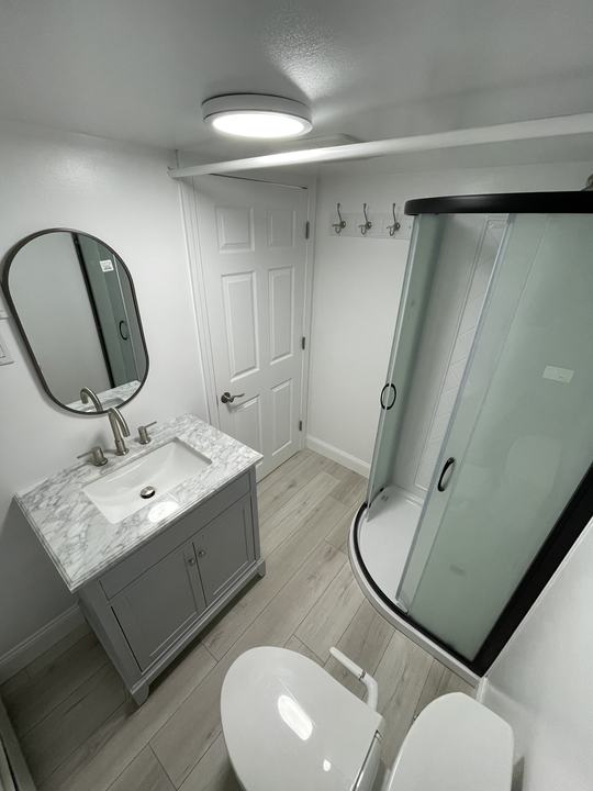 Finished basement bathroom with a glass shower
