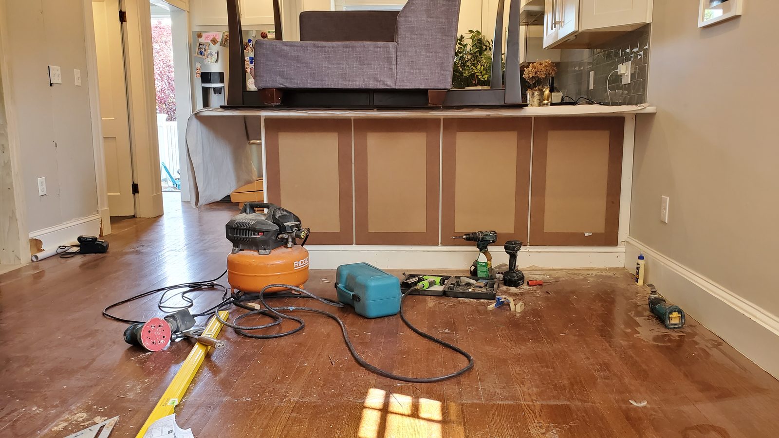 Renovation in progress with new cabinets and tools on site