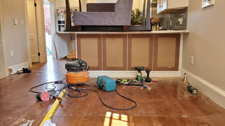 Renovation in progress with new cabinets and tools on site