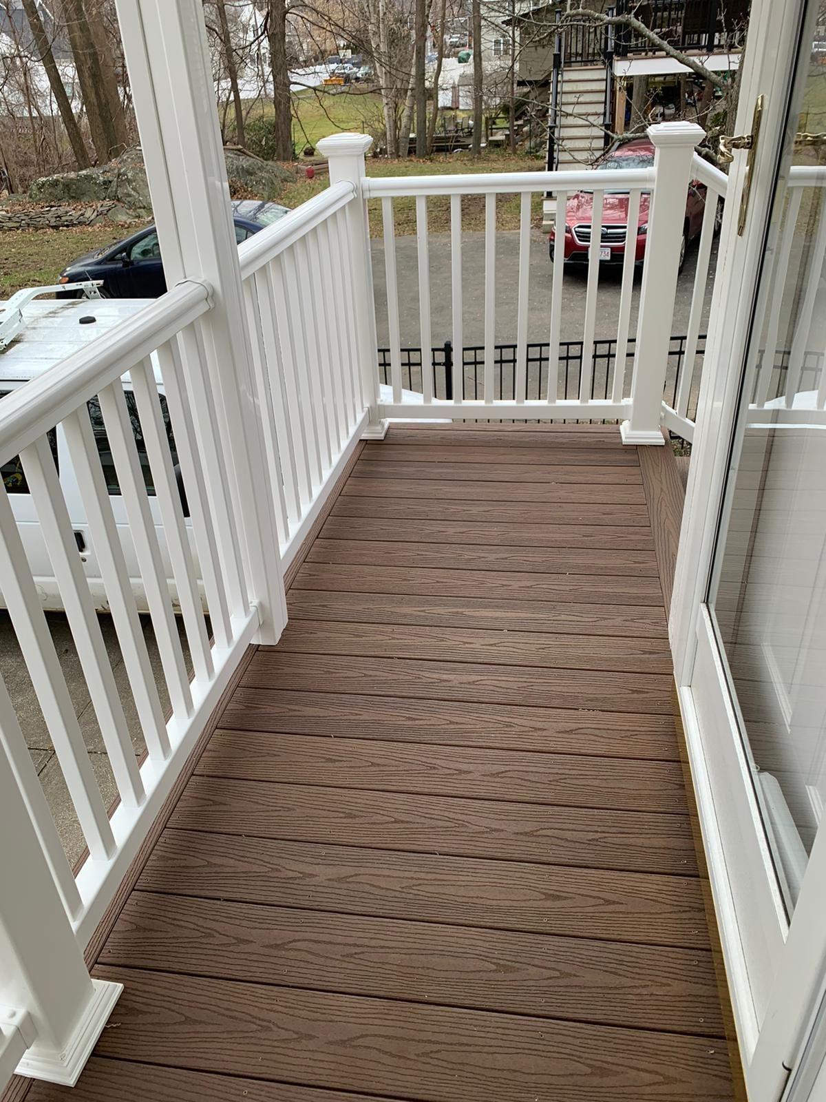 Rebuilt porch stairs with white railings and composite treads
