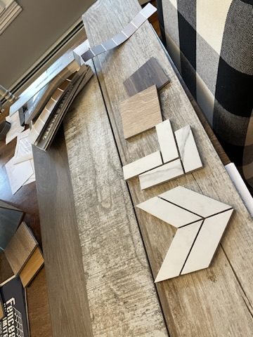 Flooring and tile samples laid out during a design meeting