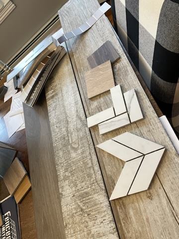Flooring and tile samples laid out during a design meeting