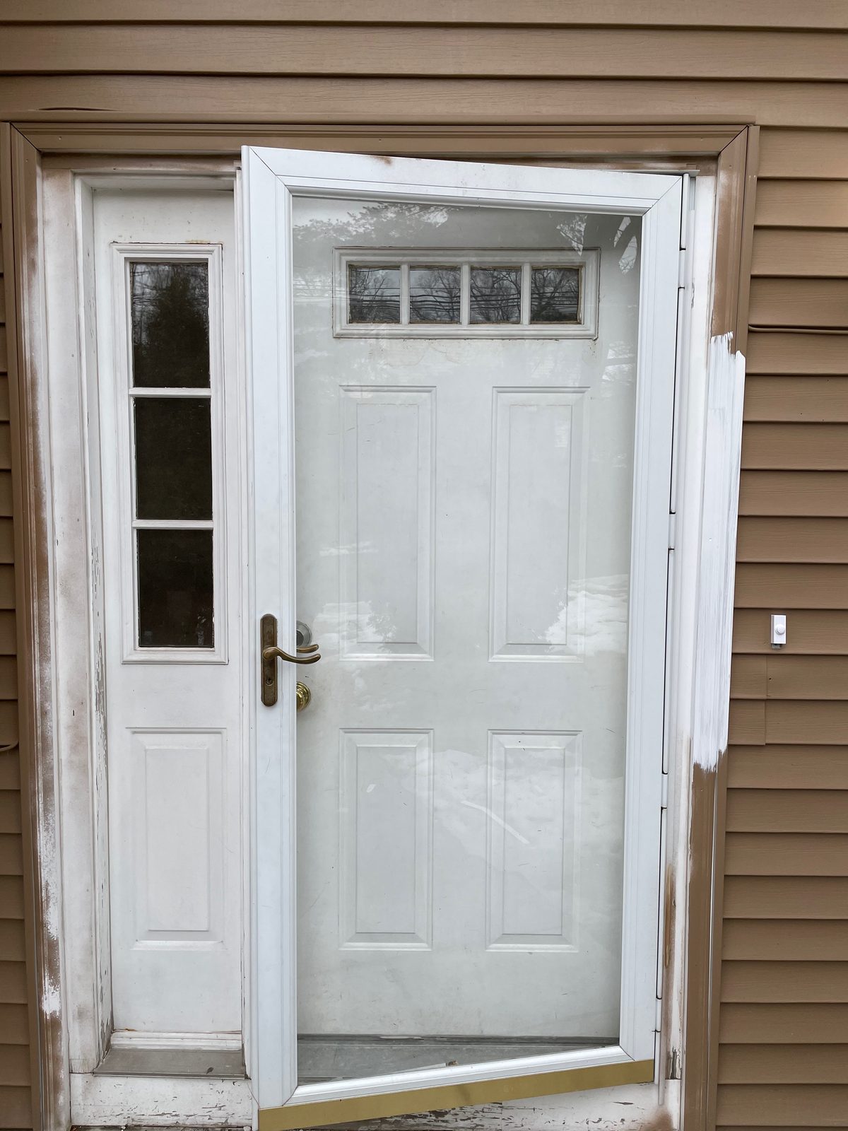 New exterior door installed on a house with wood siding