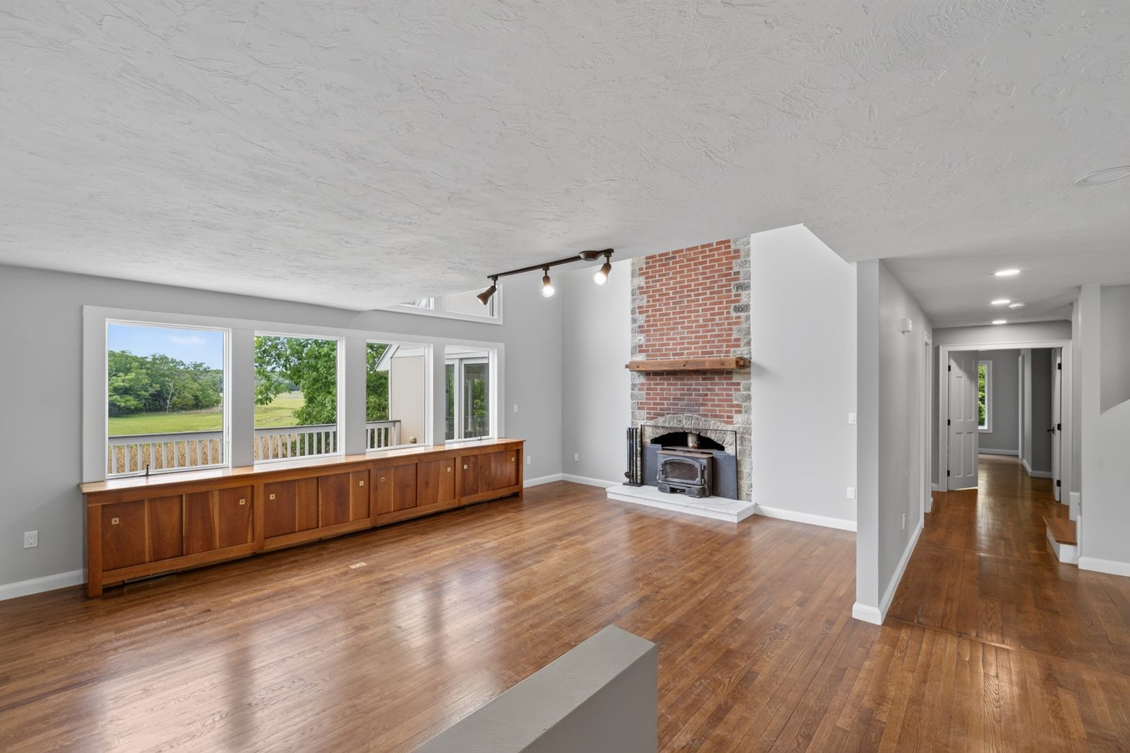 Bright, warm renovated living room with new floors and windows