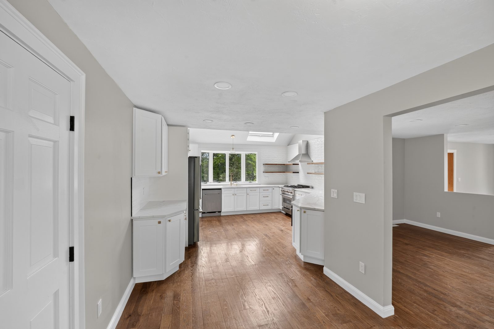 Renovated hallway and living space with ceiling-mounted detectors