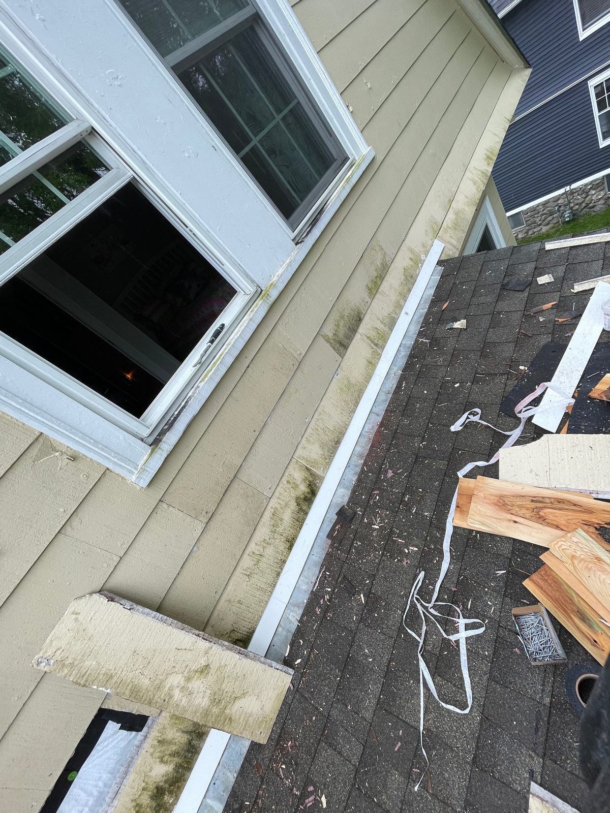 Exterior siding and window trim repair on an older house