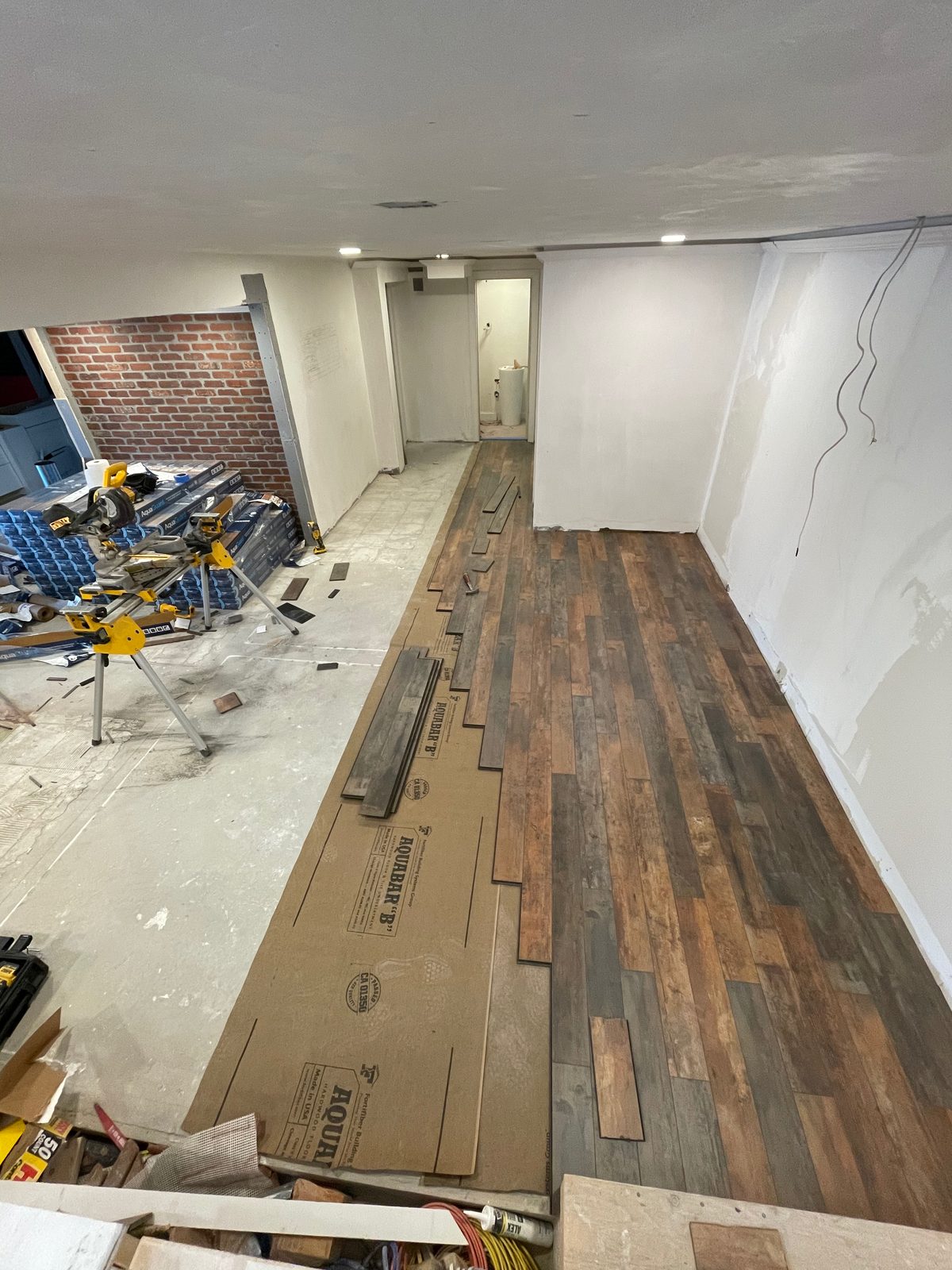 New wood-look flooring being installed during a renovation