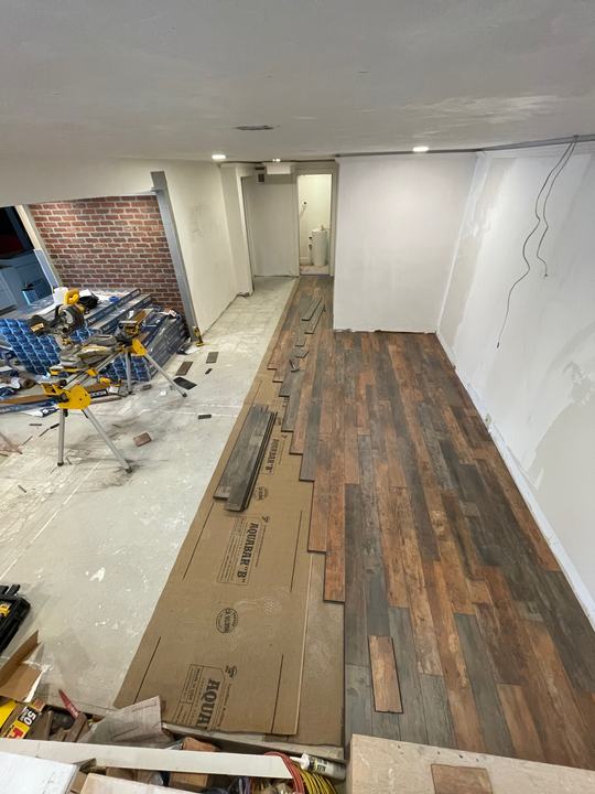 New wood-look flooring being installed during a renovation