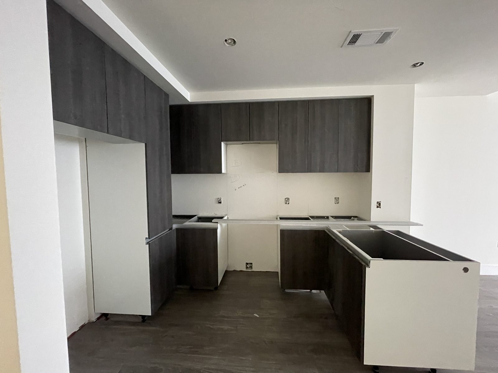 Kitchen cabinets being installed mid-project