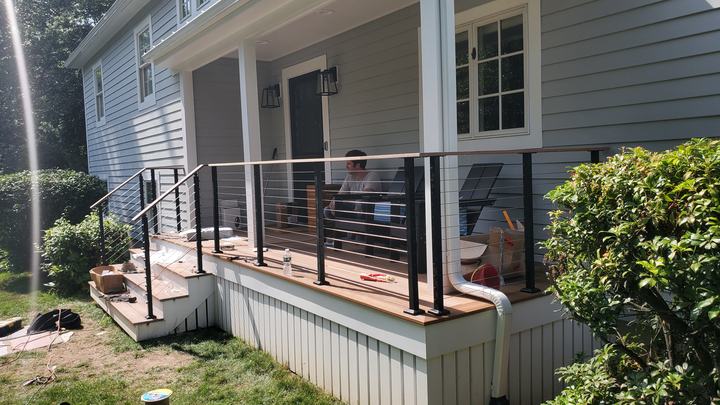 Rebuilt front porch with new decking, stairs and metal railings