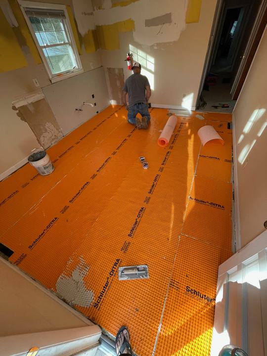 Bathroom floor waterproofing membrane installed mid-remodel